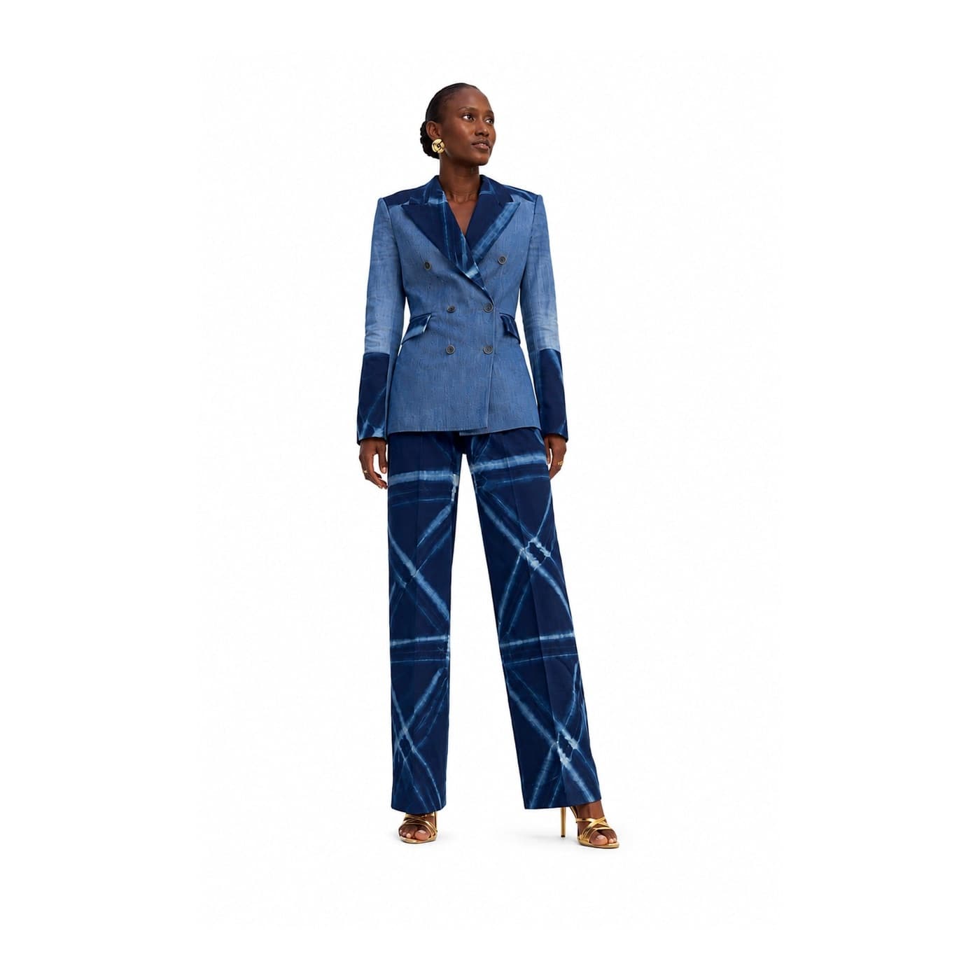 Model wearing a faded denim blazer with wide indigo adire trousers